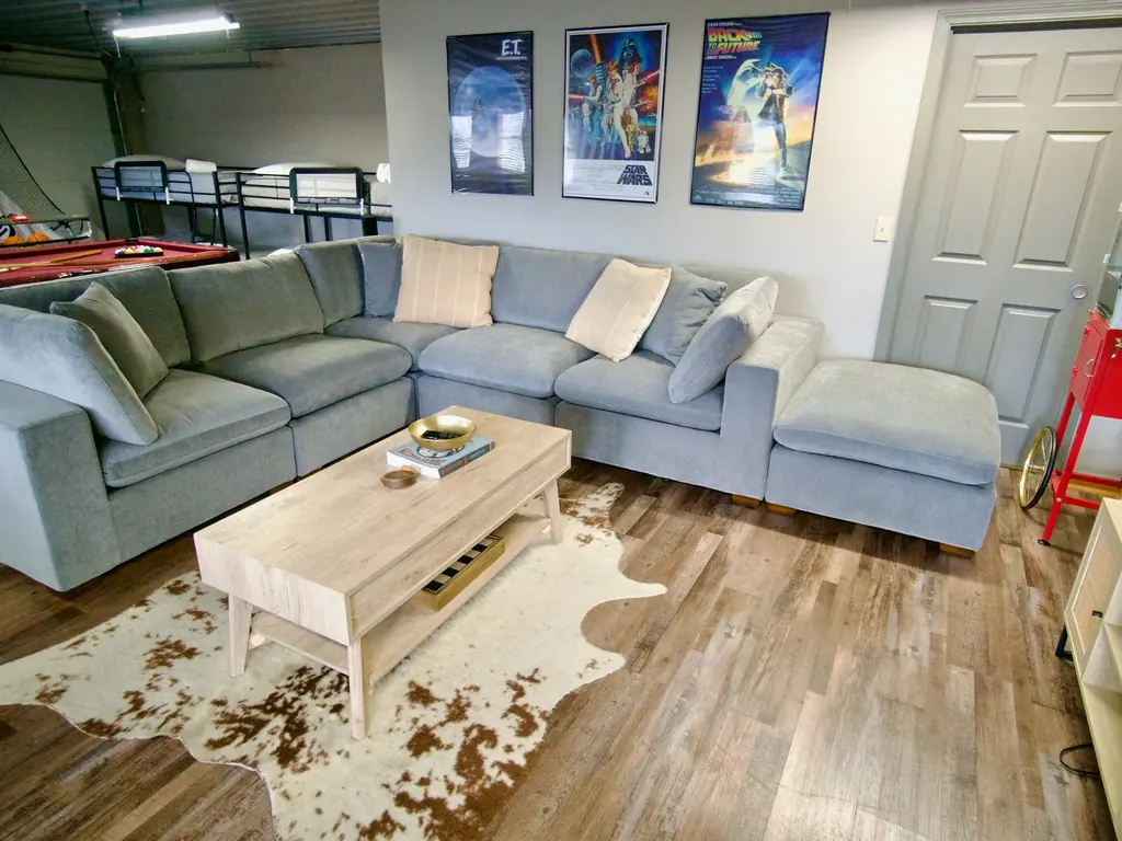 Gray sectional sofa and coffee table in the cabin's game room lounge