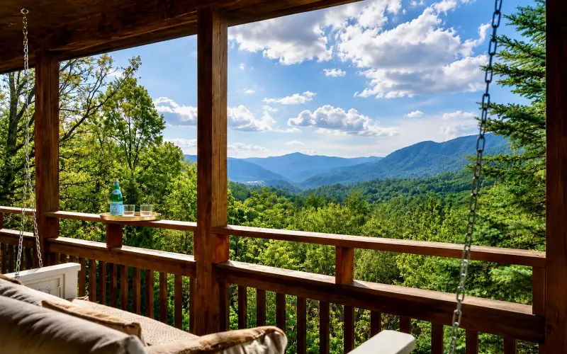 Mountain view from the cabin's main-floor deck, seen past the swinging daybed