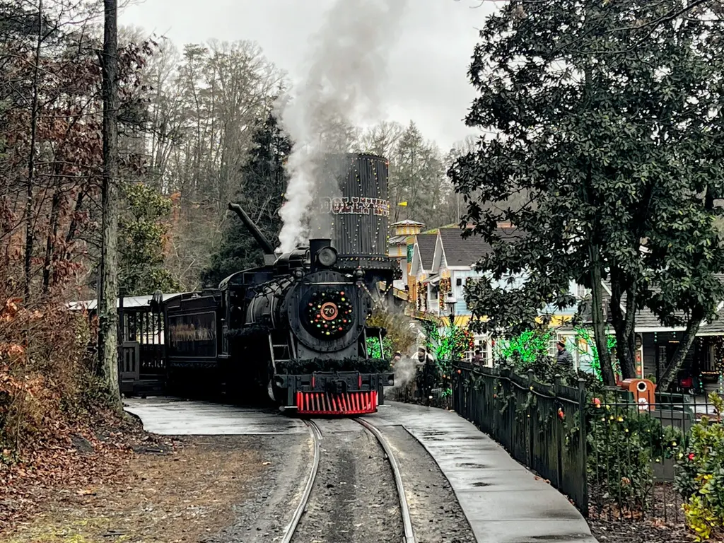 Dollywood's steam train puffing smoke on the tracks