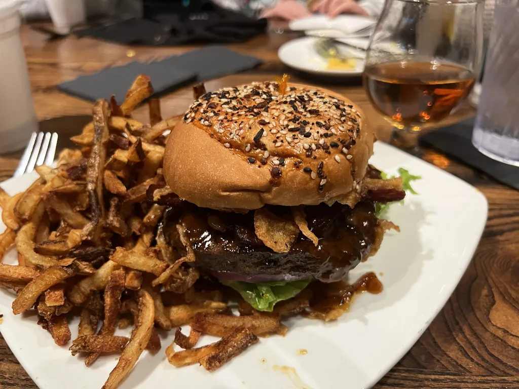 A burger with a pile of fries at The Local Goat