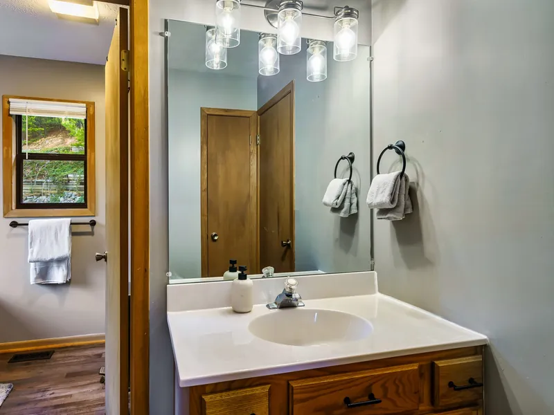 Private bathroom vanity and mirror off the second king bedroom in the cabin