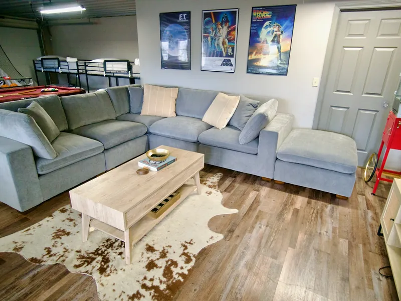 Gray sectional sofa and coffee table in the cabin's game room lounge