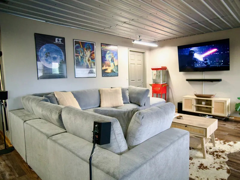 Game room lounge in the cabin with a sectional sofa facing a large-screen TV