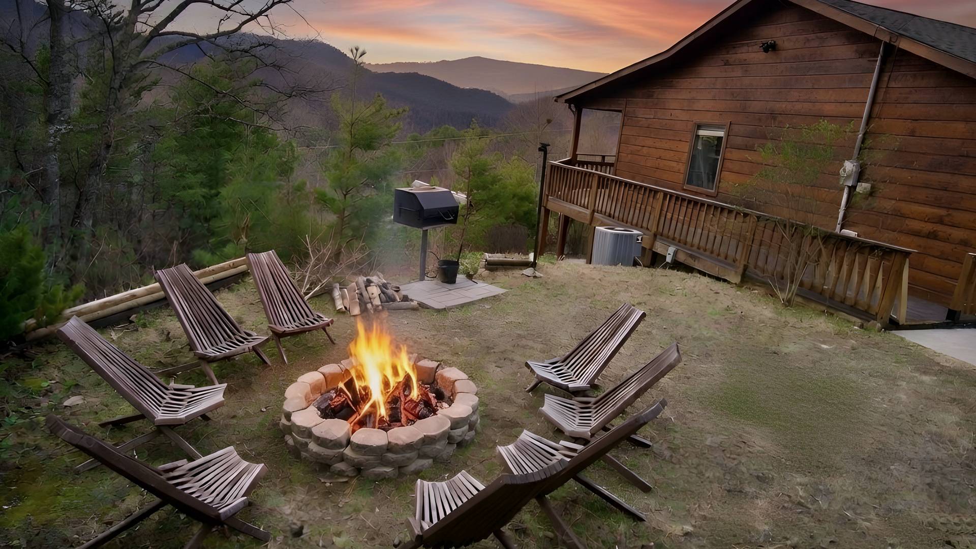 The cabin's fire pit, grill and deck with Smoky Mountain views at sunset.