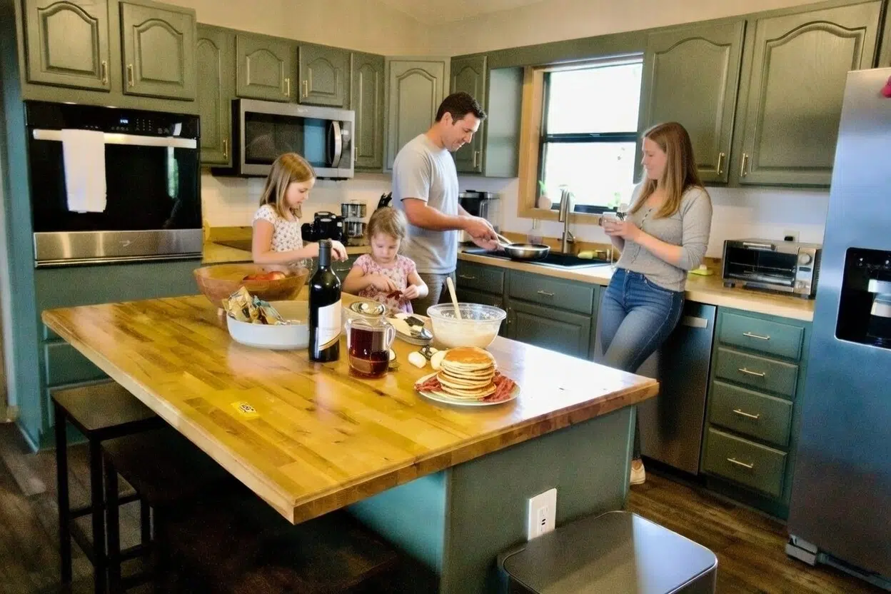 Family making pancakes in the fully equipped kitchen at Smoky Mountains Lodge cabin rental
