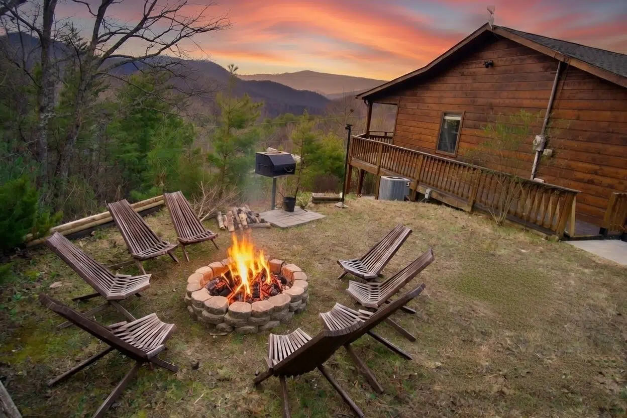 Fire pit at sunset with long-range mountain views at Smoky Mountains Lodge in Wears Valley, TN